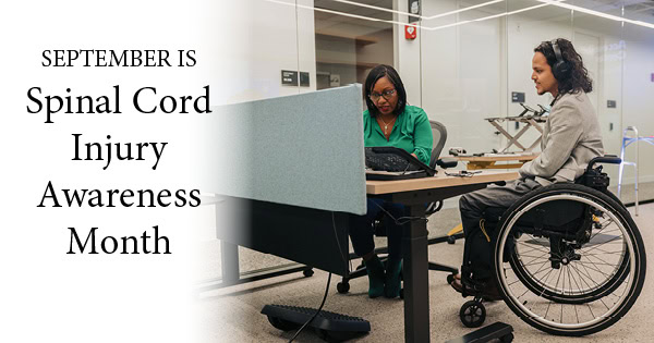 Two Colleagues Collaborate in an Accessibility Solutions Center during September for Spinal Cord Injury Awareness Month