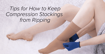 A woman putting on compression stockings with blue gloves as she tries to keep compression stockings from ripping