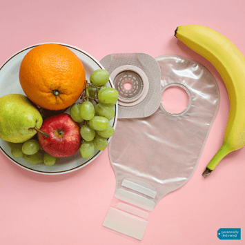 a bowl of fruit and a banana with an ostomy pouch and a skin barrier in between